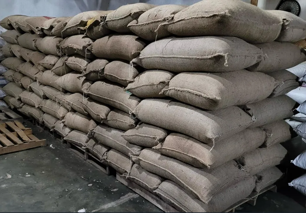 Coffee packed in burlap sacks and stacked for handling